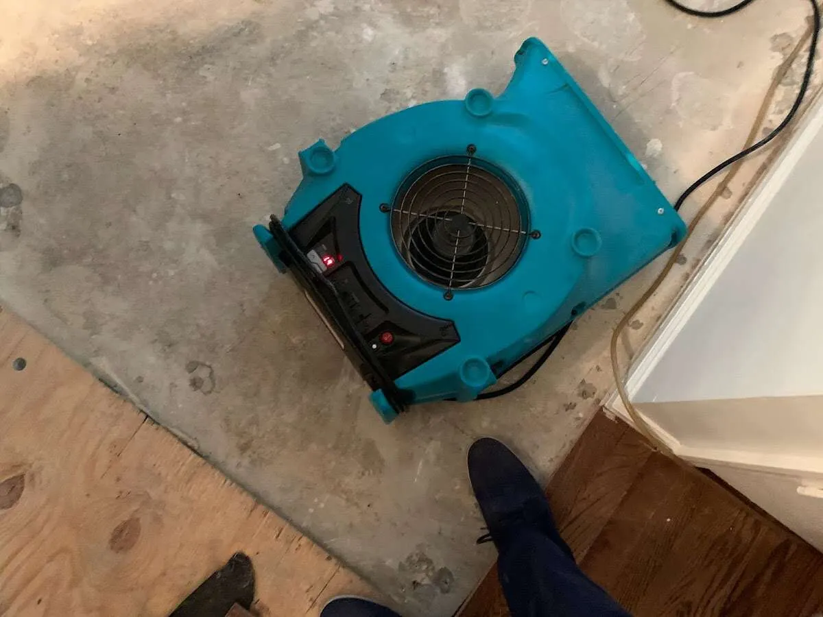 Air mover drying subfloor during Leak Detection & Repair in Quantico Base